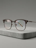 Club Master Frame – gunmetal browline with tortoise temples, 3/4 angle on stone surface