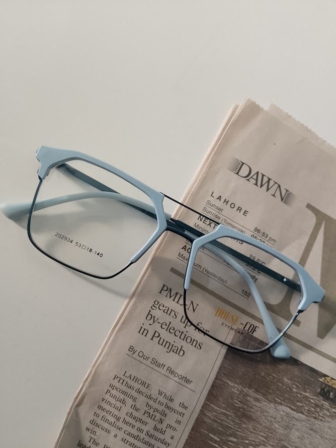 Light blue rectangular stylish eyeglass frames resting on a newspaper, modern optical glasses for daily wear