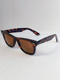 sun glasses tortrise shell frame on white surface 