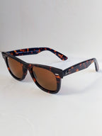 sun glasses tortrise shell frame on white surface 