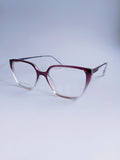 A pair of cat-eye eyeglasses with a translucent burgundy-to-clear gradient frame and clear lenses, displayed on a light gray gradient background.