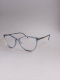 Light blue cat-eye eyeglasses with a translucent acetate frame and thin metal temples, displayed on a neutral light gray background.