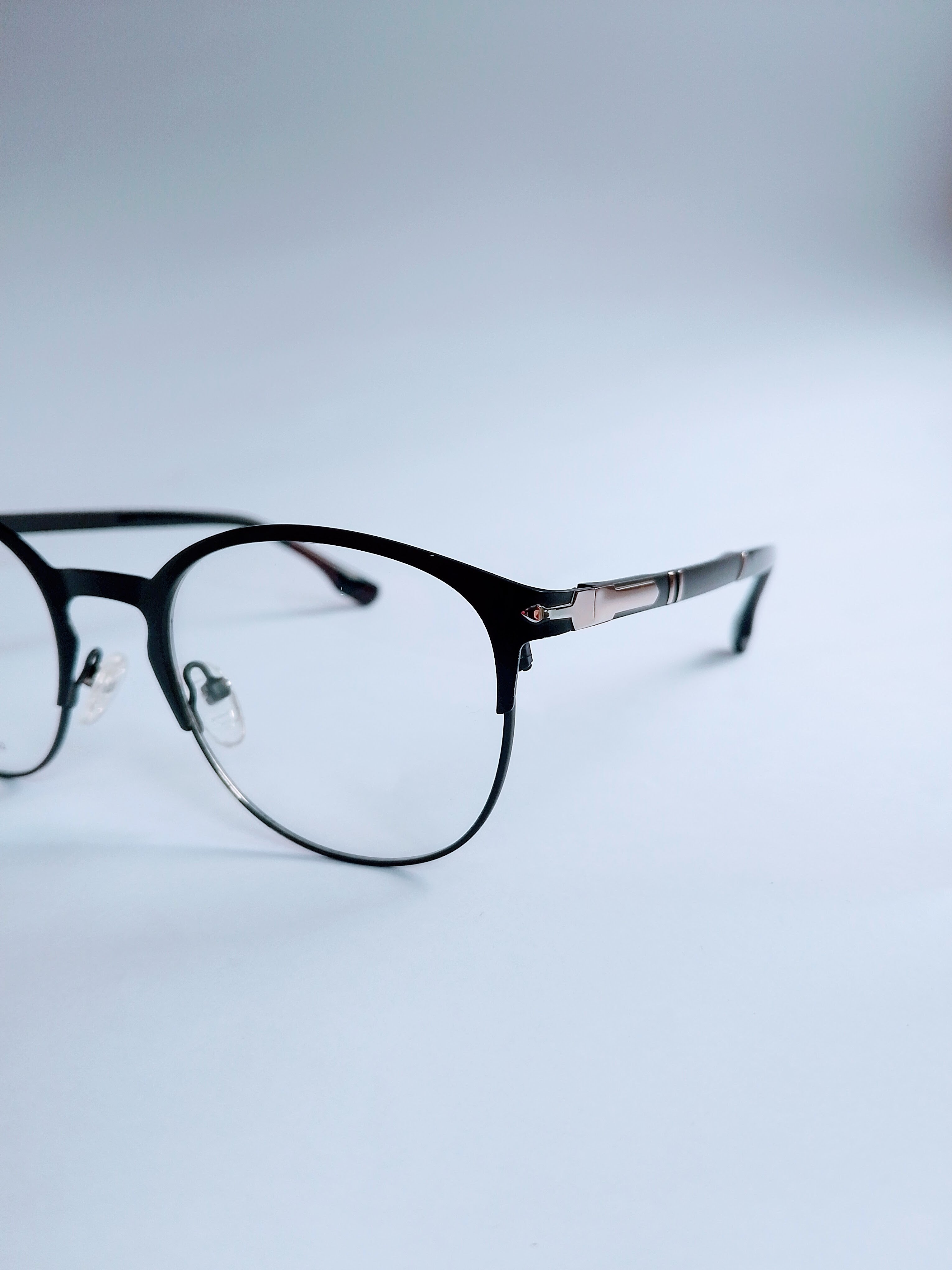 Parsole Frame – matte black half-rim frame, 3/4 angle showing silver hinge detail