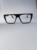 Black oversized square eyeglasses with clear lenses, displayed on a light gray background.