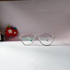 A pair of clear-framed eyeglasses with light blue-tinted lenses, resting on a white surface against a light pink background.