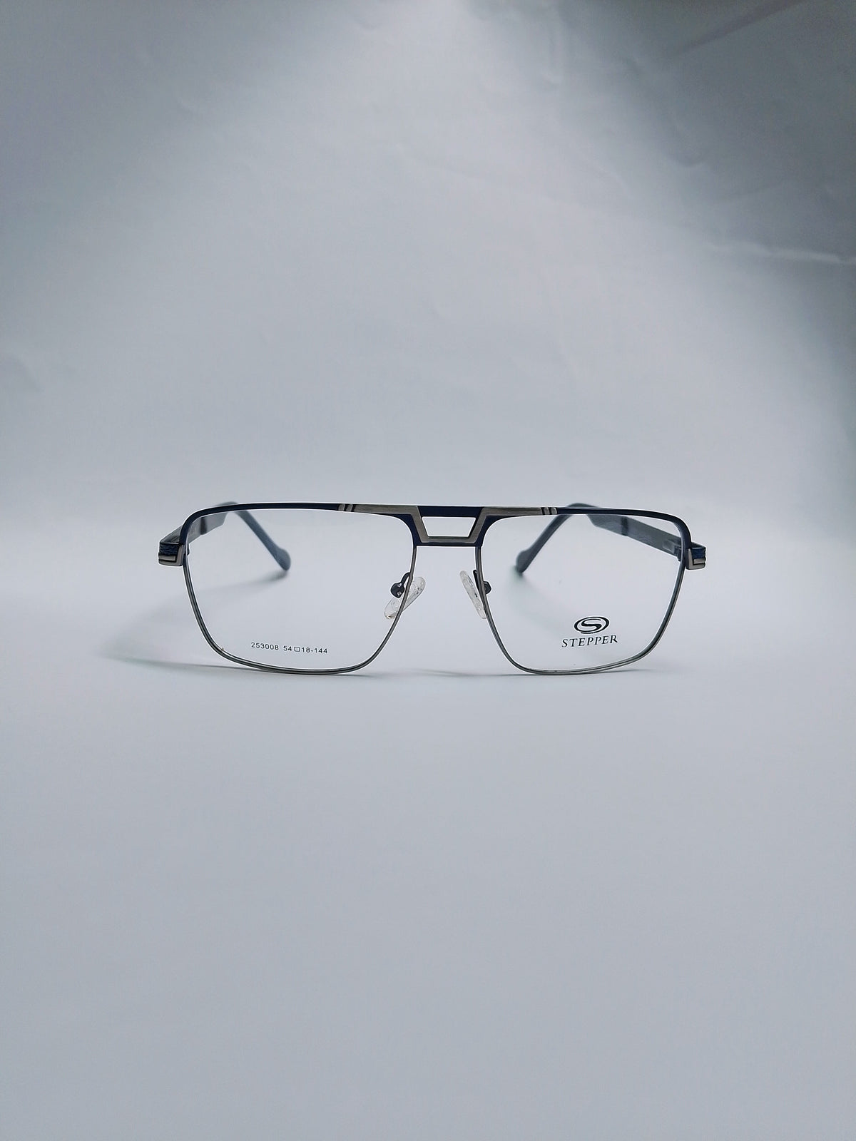 A pair of square metal eyeglass frames in royal blue color with  clear lenses, displayed on a light gray studio background. 
