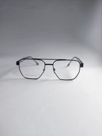 A pair of aviator-style eyeglasses with a thin black metal frame and clear lenses, displayed on a neutral gray background.
