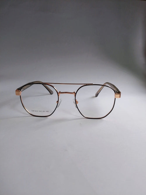 A pair of aviator-style eyeglasses with a thin rose gold metal frame and clear lenses, resting on a neutral gray surface.