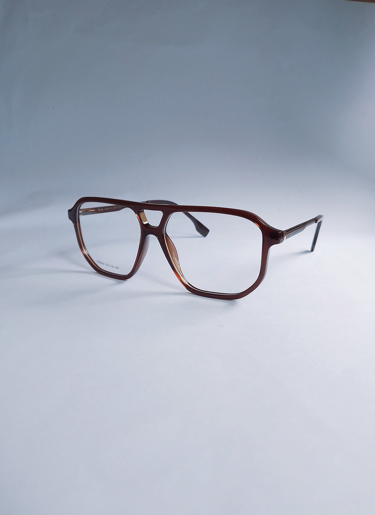 A pair of aviator-style eyeglasses with a translucent dark brown acetate frame and clear lenses, displayed on a light gray studio background.