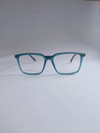 A pair of square-frame eyeglasses with translucent teal-blue frames and clear lenses, displayed on a light gray background.