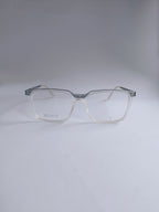 A pair of square-framed eyeglasses with a translucent clear acetate body and a contrasting silver metal top bar, shown on a neutral light gray background.