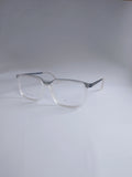 Clear acetate square eyeglasses with silver metal temples, displayed on a light gray studio background.