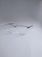 Clear acetate square eyeglasses with silver metal temples, displayed on a light gray studio background.