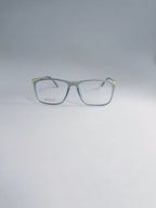 A pair of square eyeglasses with a translucent light blue acetate frame and gold metal temples, displayed on a clean light gray background.