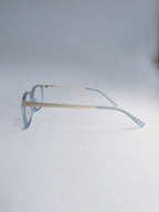Light blue acetate sunglasses with gold metal bridge and temples, displayed on a clean light gray background.