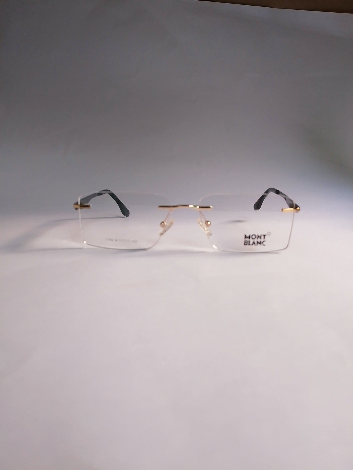 Orin lightweight rimless frame side view with gold and black detailing