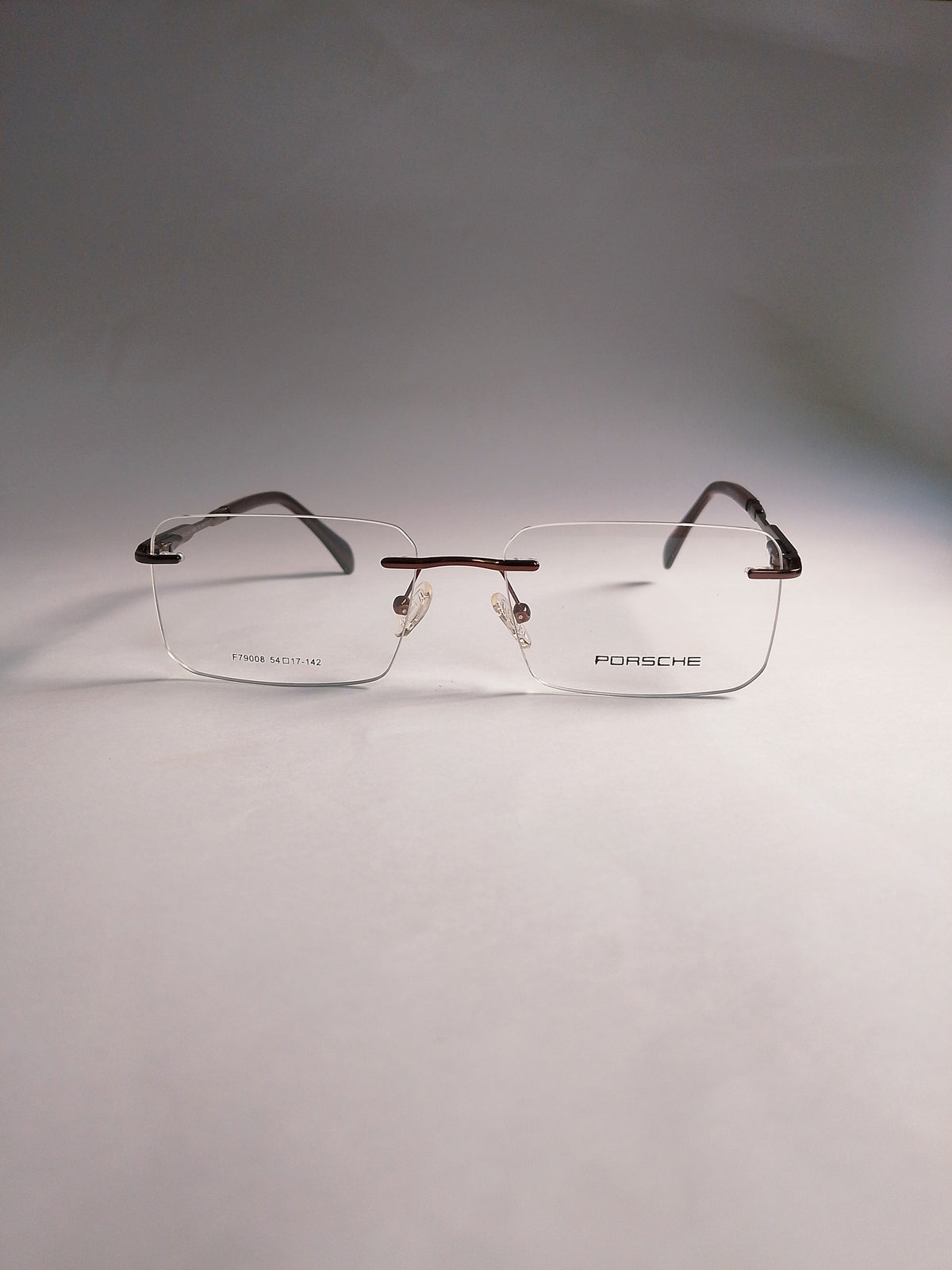  rimless eyeglasses with clear lenses and dark brown temples, displayed on a neutral gray background.