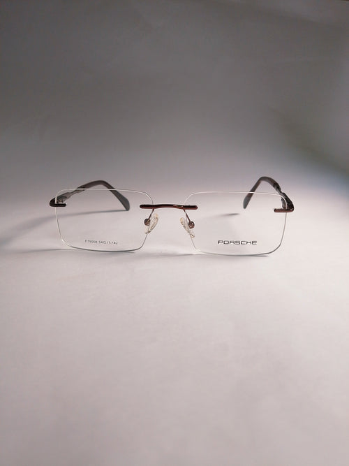  rimless eyeglasses with clear lenses and dark brown temples, displayed on a neutral gray background.