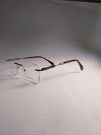  rimless eyeglasses with a dark brown woodgrain finish on the temples and clear lenses, displayed on a neutral gray background.