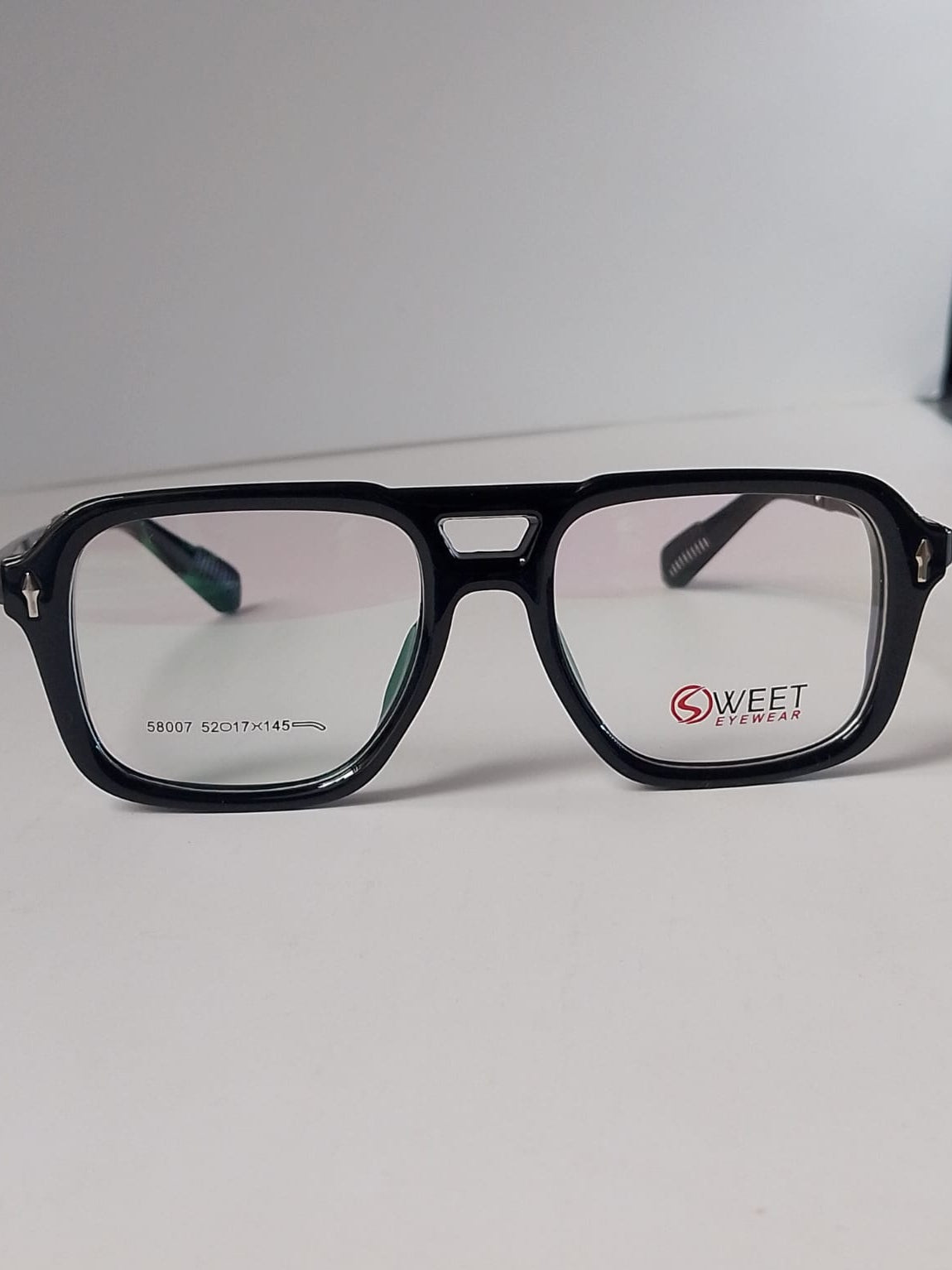  A stylish black color wayfarer on white surface and white background