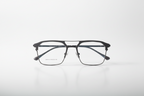 Modern black rectangular eyeglasses with sleek metal frame and clear lenses, minimalist studio shot