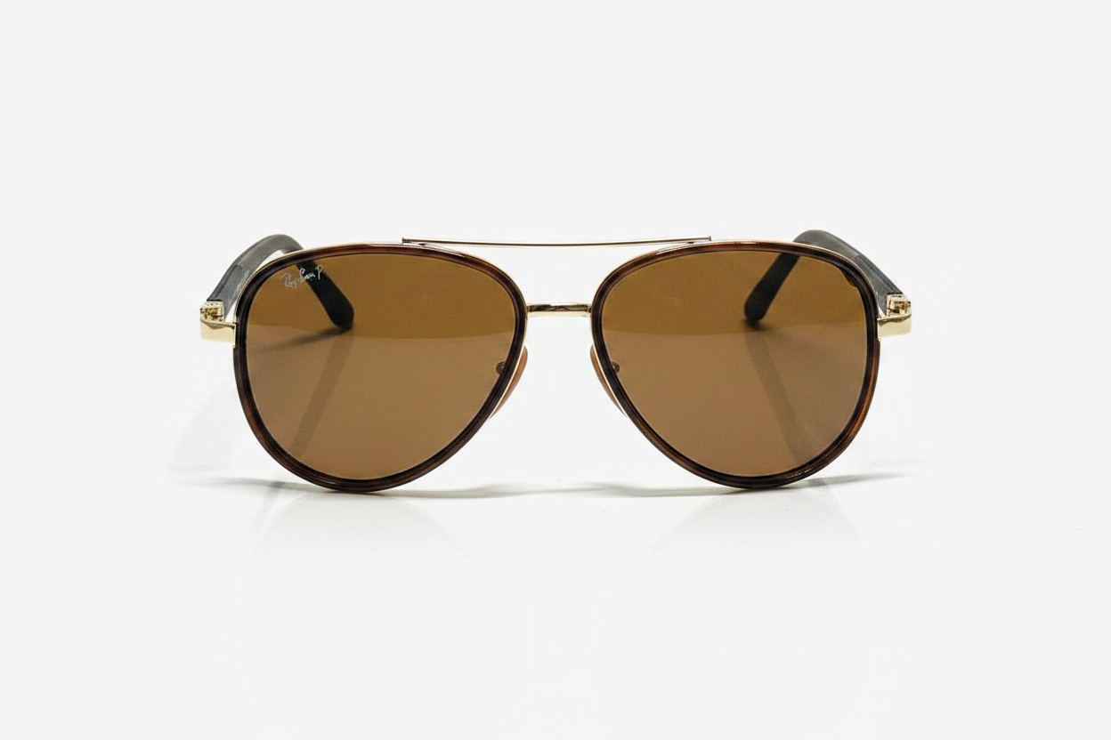 Ray-Ban aviator sunglasses with brown lenses and gold frame on white background