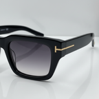 Black  stylish sunglasses with gold accents on a white surface