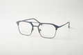 Modern geometric blue-gray eyeglass frames with clear lenses on white background