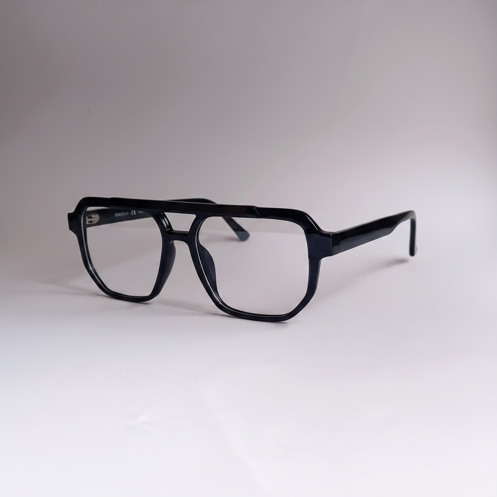 Black oversized square eyeglasses with a double bridge and clear lenses, displayed on a neutral light gray background.by aroptic